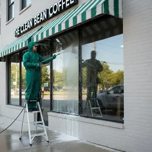 Commercial storefront window cleaning service in progress
